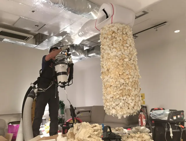 Westborough Air Duct Cleaning technician performing precision vacuum insulation removal in a residential property in Westborough